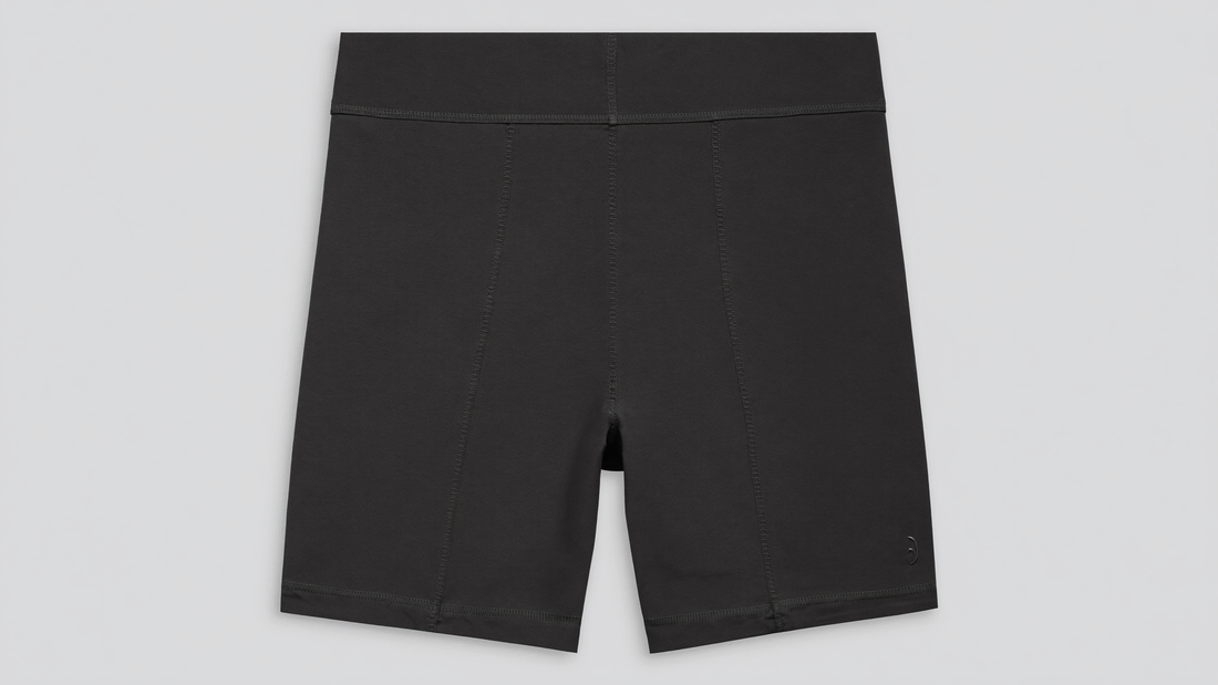 Black thigh-length anti-chafing slide shorts with smooth stretch fabric and flat seams