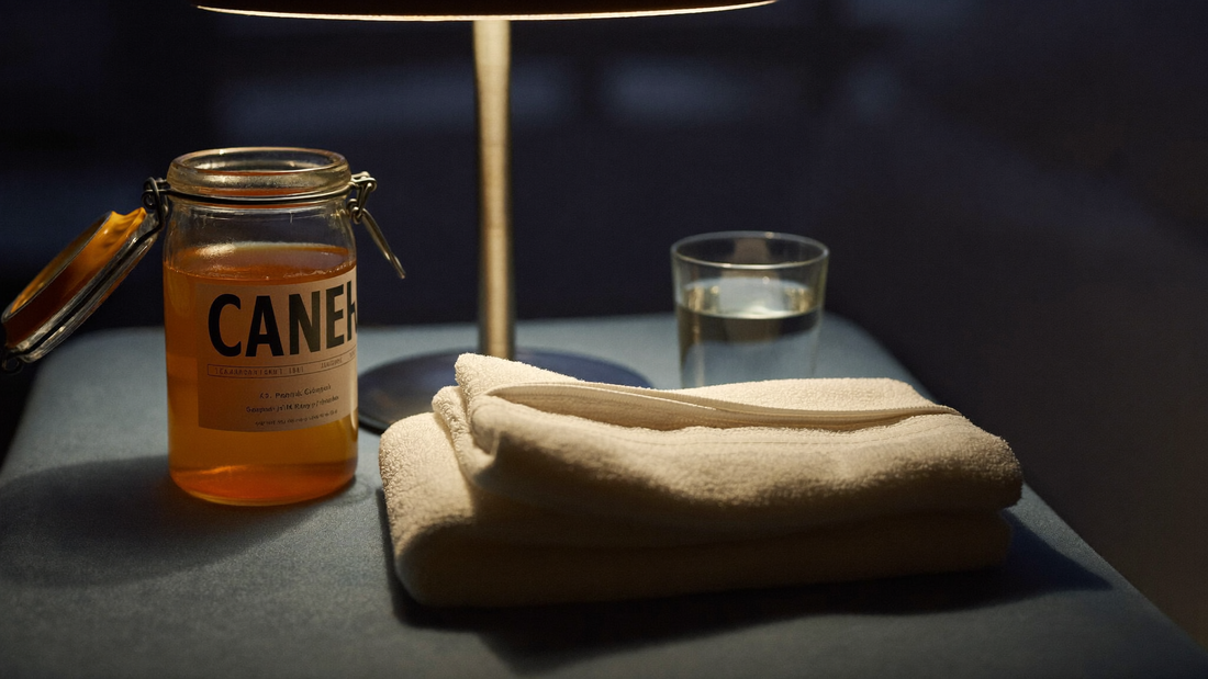 Bedside table with plain petroleum jelly, a clean towel and a glass of water at night